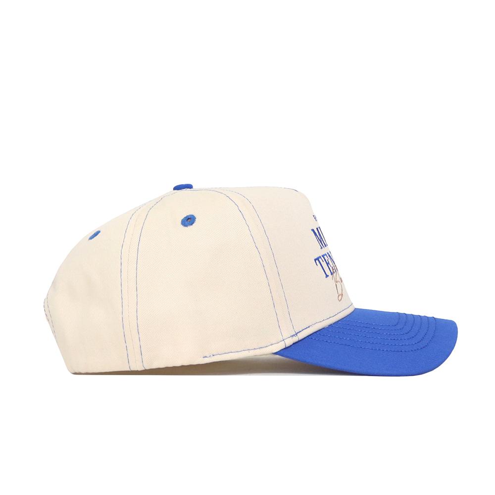 The No Rivals Middle Tennessee Vintage Hat is a cream cotton structured cap with a blue brim, button, and stitching. Shown from the side, partially visible front text adds to its classic adjustable baseball cap style.