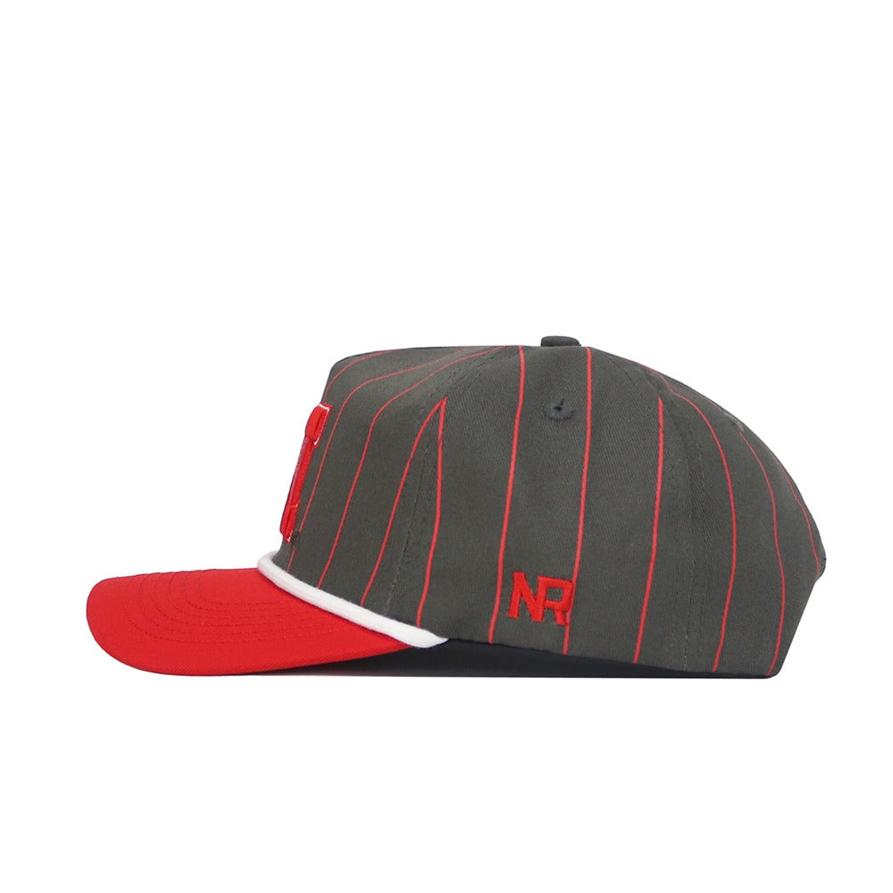 The Nebraska Gray Unstructured Hat by No Rivals features thin red pinstripes, a red flat brim with white accent, and red embroidered NR letters on the side. Made from high-quality cotton with an adjustable snapback closure.