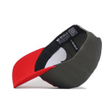 The Nebraska Gray Structured Hat by No Rivals is shown upside down, revealing a black inner lining, white design, "NO RIVALS" text, and a QR code on the structured fit inner band. It features a red brim and dark green crown.