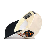 The Tennessee Alma Mater Hat - Blackout by No Rivals features a cream crown, black brim, navy football helmet with orange "H" on the side, and a NO RIVALS label inside. Made from quality cotton with snapback adjustment for a perfect fit.