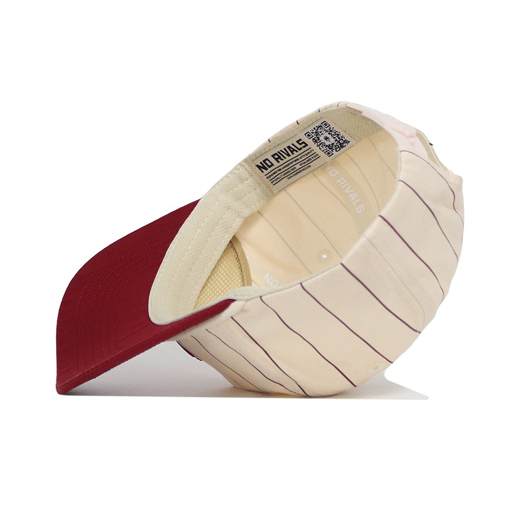 The Alabama Pinstripe Hat by No Rivals features cream cotton with thin vertical burgundy stripes, a solid burgundy brim, and an interior tag reading NO RIVALS.