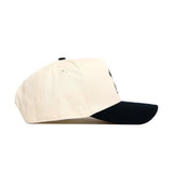 The No Rivals OSU Bear Hat features a cream color, black curved brim, and snapback closure, displayed side view on a white background.