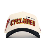 The No Rivals Iowa State Punching Cy Alma Mater Hat - Classic is a white and black snapback, featuring IOWA STATE and CYCLONES in gold and red on the front, a Cyclones mascot logo on the left side, and is crafted from high quality cotton.