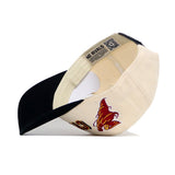 The Iowa State Punching Cy Alma Mater Hat - Classic by No Rivals is pictured upside down, showing the inside with a red and yellow wildcat head embroidered on the side and a NO RIVALS label on the inner band.