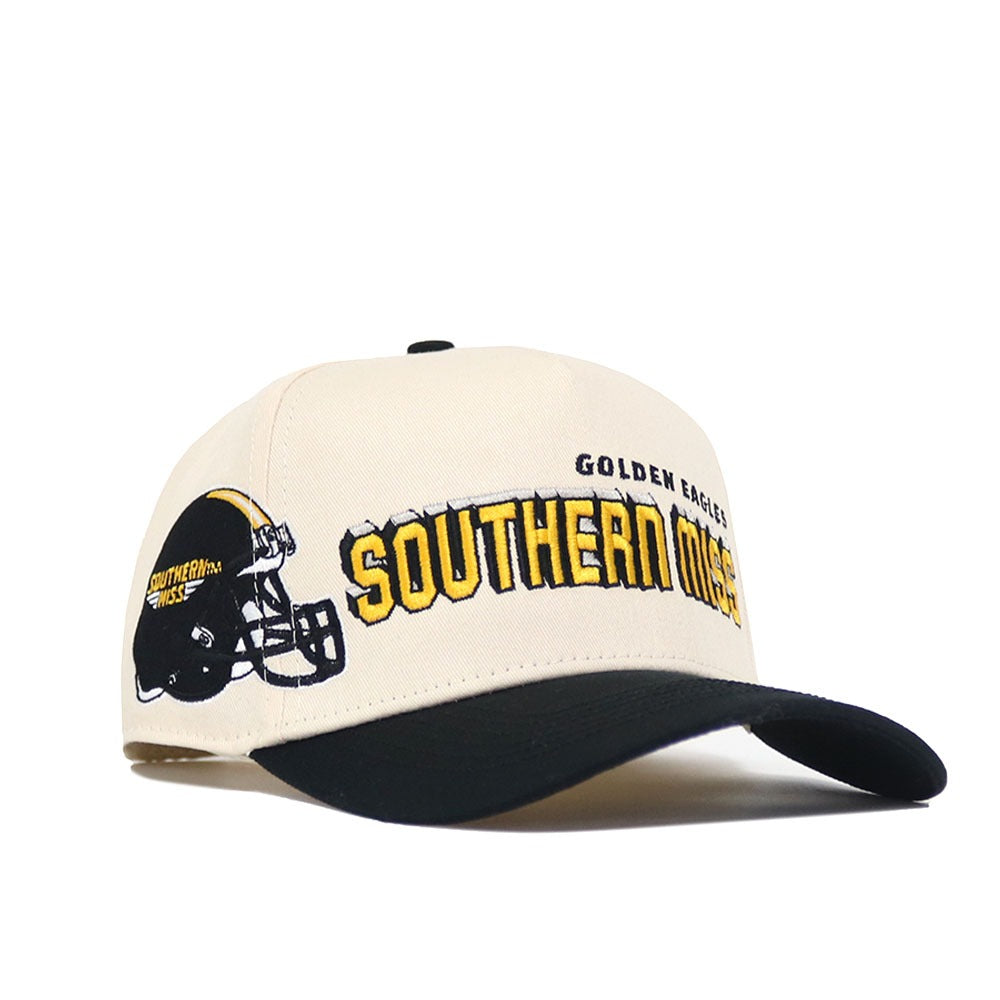 The Southern Miss Alma Mater Hat by No Rivals is a beige and black snapback with a football helmet graphic, embroidered “Golden Eagles Southern Miss” on front and side, plus officially licensed logos.