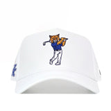 The No Rivals Kentucky Golf Hat - White features an embroidered cartoon wildcat in a blue shirt and white pants swinging a golf club on the front, plus a snap back closure for the perfect Gameday Fit.