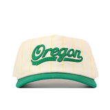 The Oregon Pinstripe Hat by No Rivals features thin yellow stripes, a green brim, "Oregon" in bold green script on the front, and an embroidered logo.