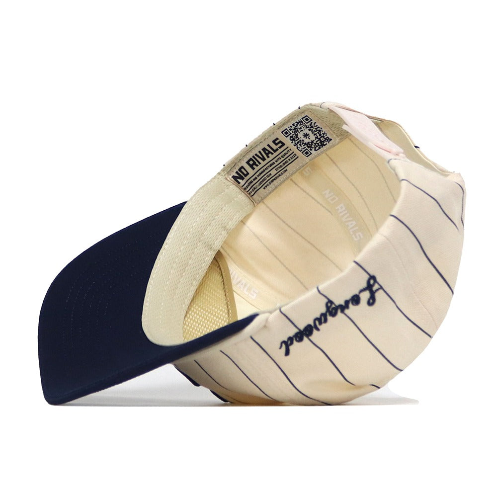 The Longwood Pinstripe Hat by No Rivals is shown from the inside, featuring a navy brim, embroidered “Forgotten” script, and an inner “NO RIVALS” label. This snapback offers all-day comfort with its adjustable fit and classic pinstripe design.