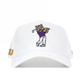 Show your LSU spirit in the No Rivals LSU Golf Hat – Swinging – White, featuring an embroidered cartoon tiger golfer in a purple shirt and white pants, golf club raised. Finished with an embroidered logo and adjustable snap back closure for the perfect gameday fit.