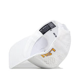 The LSU Golf Hat - Swinging in white by No Rivals is shown from underneath, featuring ventilation holes, a yellow embroidered LSU logo, and an inner band label with the words "NO RIVALS" and a QR code. The snapback adjustment provides a comfortable fit for gameday.