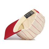 The Indiana University Pinstripe Hat by No Rivals features a red and cream color scheme with thin red stripes on the outside and a solid red visor. Flipped upside down, it reveals a cream lining printed with “NO RIVALS.” Its unstructured fit and snapback adjustment provide a comfortable, one-size-fits-most design.