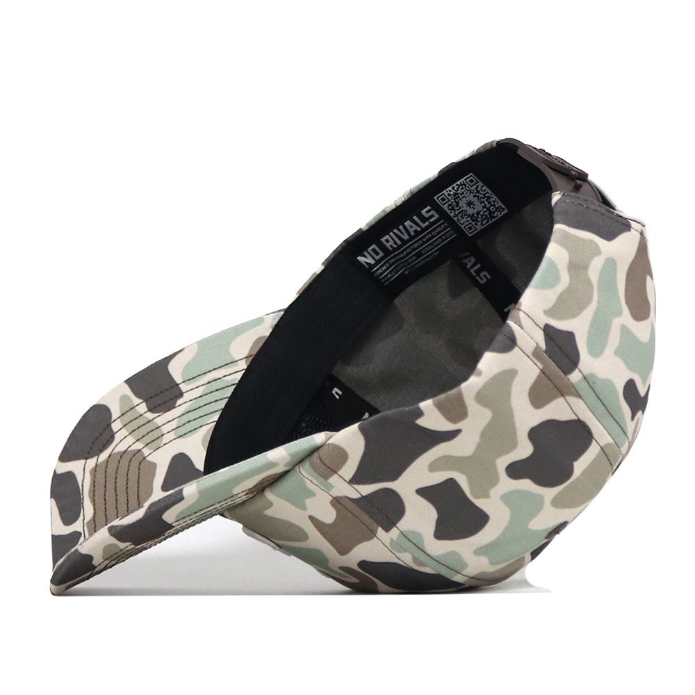 The Alabama Crimson Tide Huntsman Hat by No Rivals is a camouflage-patterned snapback baseball cap, shown upside down to reveal the interior label reading “No Rivals.” Crafted from high-quality cotton, this hat ensures both durability and comfort.