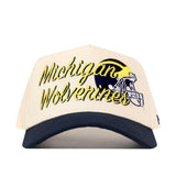 The No Rivals Michigan Wolverines Script Overlay Hat is a beige and navy blue snapback featuring an officially licensed embroidered logo and a football helmet graphic on the front.