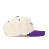 Show off your team pride with the No Rivals Kansas State Wildcats Vintage Hat—a cream-colored snapback featuring a purple brim, button, and stitching, shown from the side. Expertly crafted from high-quality cotton, this cap delivers both comfort and classic style to top off your gameday look.