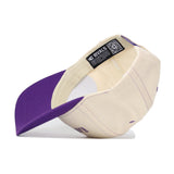 A cream Kansas State Wildcats Vintage Hat by No Rivals, featuring a purple bill and shown inside out. Crafted from high-quality cotton, this snapback cap displays an inner tag reading “No Rivals” alongside a QR code.